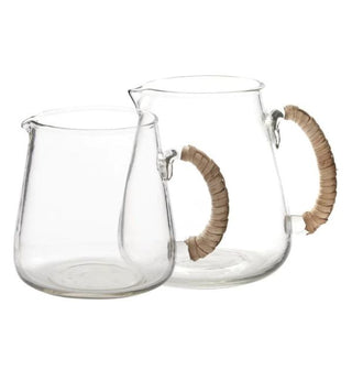 Glass pitcher with rattan wrapped handles.