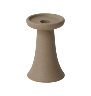 Neutral sand colored candle holder.