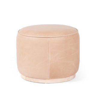 Upholstered in light top-grain leather and paired with a solid ash base, this rounded ottoman