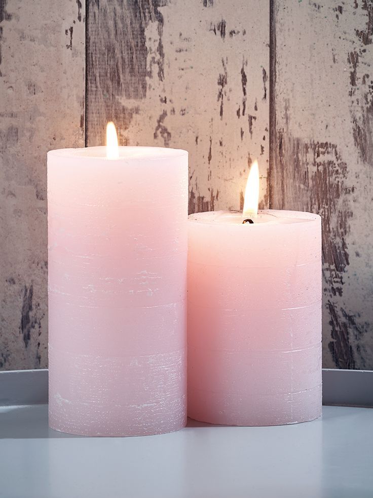 Ribbed pillar candles in white, green, pale pink, and salmon pink on white background.