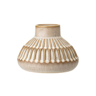 Isabella Stoneware Vase 6 inch The tan vase is covered with a white reactive glaze that creates color variations and dimension throughout the surface.