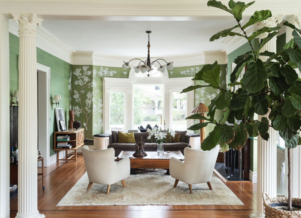 Workstead Interiors of Beauty & Necessity tan background with picture of leather couches in living room.